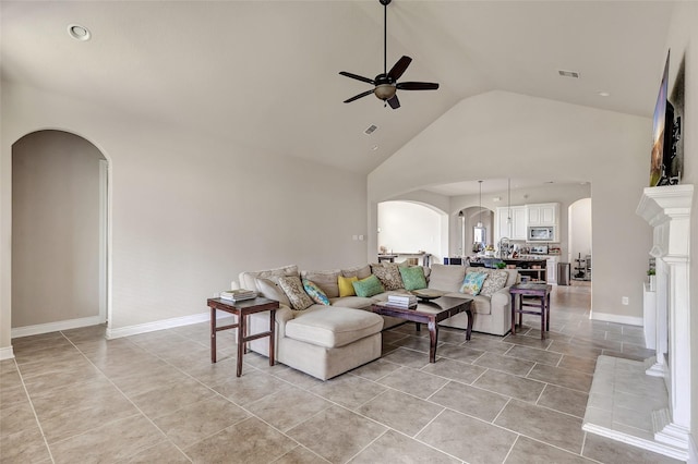 18115 Stari Most Ln, Houston, TX 77044 - living room with arched walkways, ceiling fan, high vaulted ceiling, and light tile patterned floors