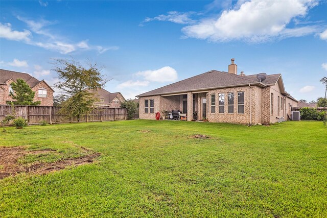 18115 Stari Most Ln, Houston, TX 77044 - back of property with a fenced backyard, a chimney, brick siding, and roof with shingles