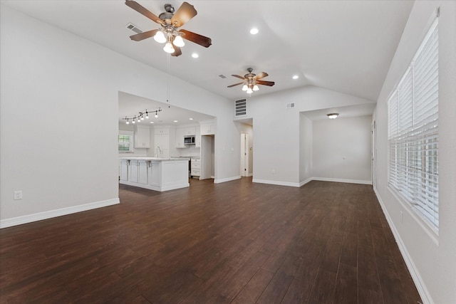 1503 Briar Cliff St, Conroe, TX 77385 - unfurnished living room featuring a ceiling fan, lofted ceiling, dark wood-style floors, and recessed lighting
