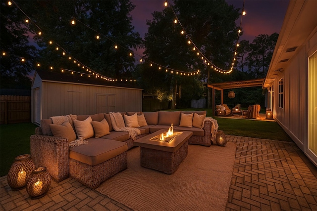 1503 Briar Cliff St, Conroe, TX 77385 - patio at night featuring an outdoor living space with a fire pit, a patio area, a pergola, a fenced backyard, and a storage shed
