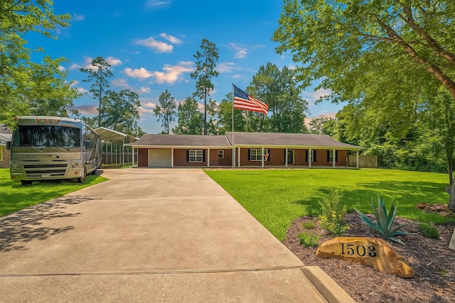 1503 Briar Cliff St, Conroe, TX 77385 - view of front of property featuring a front lawn, driveway, a garage, and brick siding