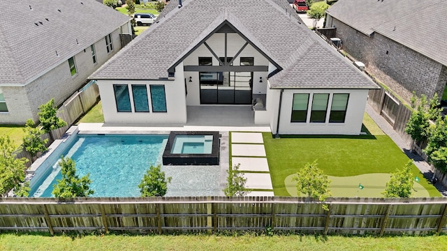 24914 Heather Glade Trl, Tomball, TX 77375 - rear view of property with stucco siding, a fenced backyard, a pool with connected hot tub, and a patio