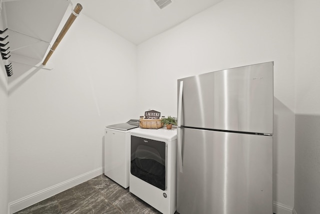 24914 Heather Glade Trl, Tomball, TX 77375 - washroom featuring dark marble finish flooring and washing machine and clothes dryer