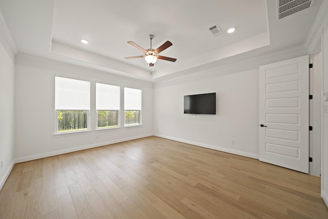 24914 Heather Glade Trl, Tomball, TX 77375 - empty room with a raised ceiling, a ceiling fan, light wood-style flooring, recessed lighting, and crown molding
