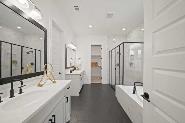 24914 Heather Glade Trl, Tomball, TX 77375 - bathroom featuring a marble finish shower, two vanities, a garden tub, tile patterned flooring, and recessed lighting