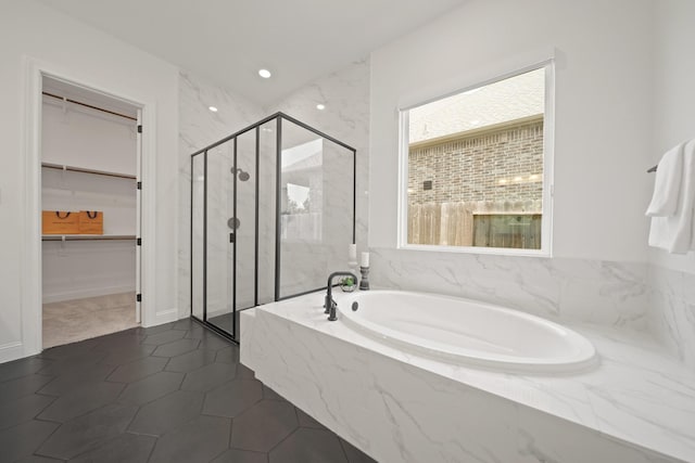 24914 Heather Glade Trl, Tomball, TX 77375 - bathroom featuring a garden tub, a marble finish shower, a walk in closet, and tile patterned flooring