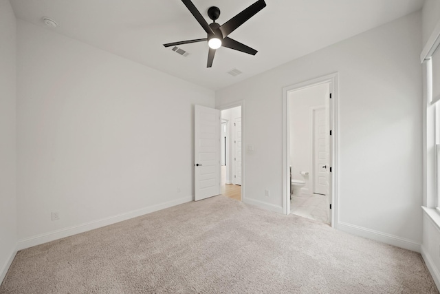 24914 Heather Glade Trl, Tomball, TX 77375 - unfurnished bedroom with light colored carpet, connected bathroom, and ceiling fan