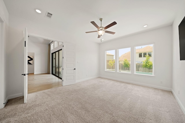 24914 Heather Glade Trl, Tomball, TX 77375 - empty room with light colored carpet, a ceiling fan, and recessed lighting