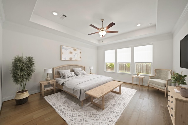 24914 Heather Glade Trl, Tomball, TX 77375 - bedroom featuring a raised ceiling, wood finished floors, recessed lighting, a ceiling fan, and ornamental molding