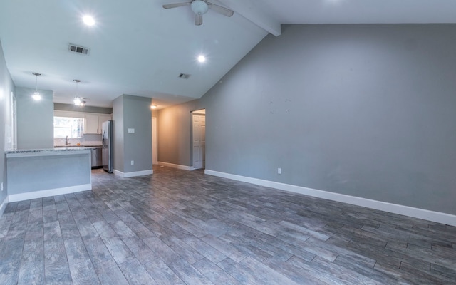 28906 Champion Oaks Dr, Magnolia, TX 77354 - unfurnished living room with dark wood finished floors, a ceiling fan, beamed ceiling, and high vaulted ceiling