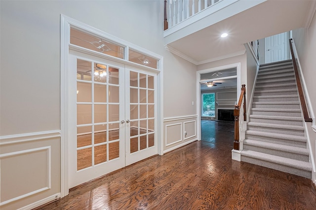 6018 Rapid Creek Ct, Houston, TX 77345 - stairway featuring a decorative wall, crown molding, wood finished floors, french doors, and a fireplace