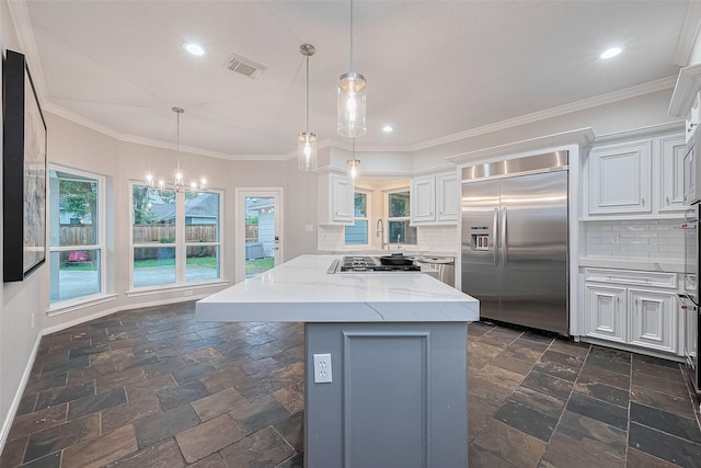 6018 Rapid Creek Ct, Houston, TX 77345 - kitchen with appliances with stainless steel finishes, stone tile flooring, a chandelier, decorative backsplash, and recessed lighting