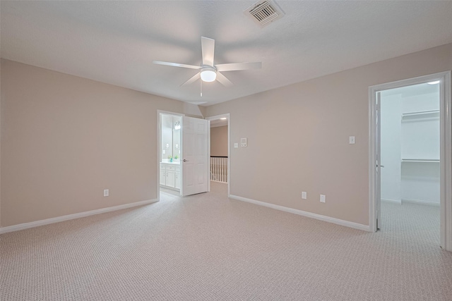 6018 Rapid Creek Ct, Houston, TX 77345 - unfurnished bedroom featuring light colored carpet, a spacious closet, ceiling fan, ensuite bath, and a closet