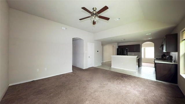 6903 Rosemont Ct, Rosharon, TX 77583 - unfurnished living room featuring arched walkways, a ceiling fan, and light colored carpet