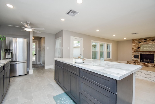 7618 Highmeadow Dr, Houston, TX 77063 - kitchen featuring stainless steel refrigerator with ice dispenser, light stone countertops, ceiling fan, open floor plan, and recessed lighting
