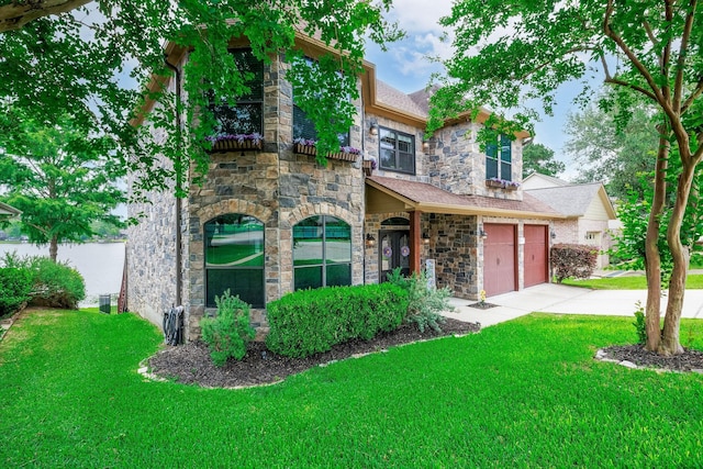 1600 Wimbledon Dr, Huntsville, TX 77340 - view of front of house featuring stone siding, a front yard, concrete driveway, and a garage