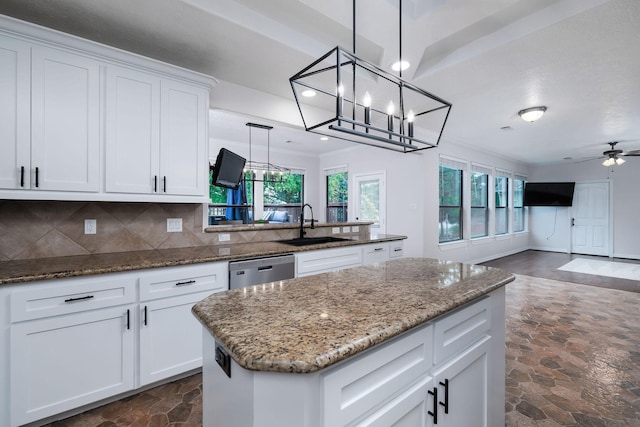1600 Wimbledon Dr, Huntsville, TX 77340 - kitchen featuring dark stone finish flooring, dishwasher, a chandelier, a kitchen island, and tasteful backsplash