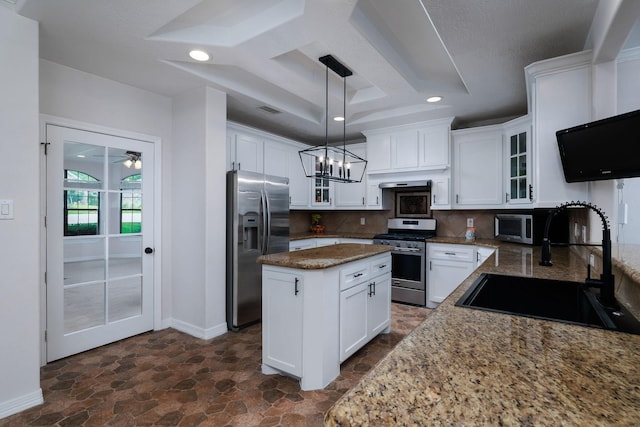 1600 Wimbledon Dr, Huntsville, TX 77340 - kitchen with stainless steel appliances, dark stone finish flooring, backsplash, a kitchen island, and glass insert cabinets
