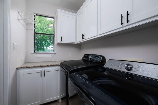 1600 Wimbledon Dr, Huntsville, TX 77340 - laundry area with washer and clothes dryer and cabinet space