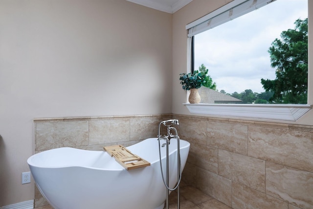 1600 Wimbledon Dr, Huntsville, TX 77340 - full bathroom with tile walls, a soaking tub, wainscoting, and ornamental molding