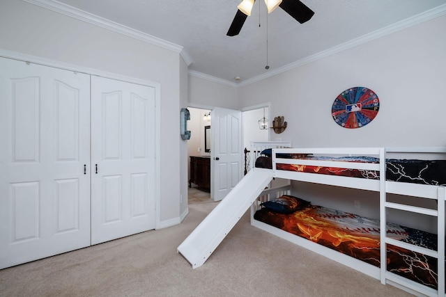 1600 Wimbledon Dr, Huntsville, TX 77340 - carpeted bedroom featuring ornamental molding, ceiling fan, a closet, and connected bathroom