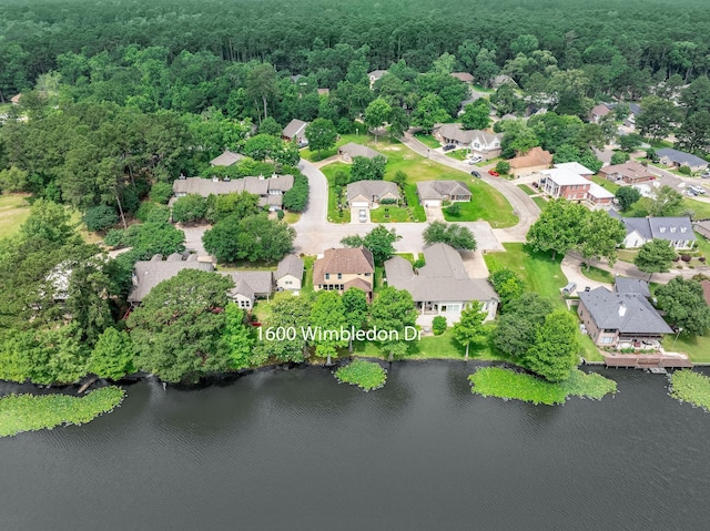1600 Wimbledon Dr, Huntsville, TX 77340 - aerial perspective of suburban area with a heavily wooded area and a nearby body of water