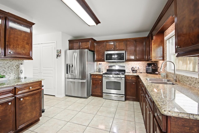 1202 Fairlane Sq, Channelview, TX 77530 - kitchen featuring appliances with stainless steel finishes, tasteful backsplash, light stone countertops, and light tile patterned floors