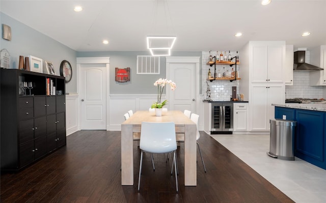 1719 Guese Rd, Houston, TX 77008 - dining area featuring wine cooler, a dry bar, wainscoting, recessed lighting, and dark wood-style flooring