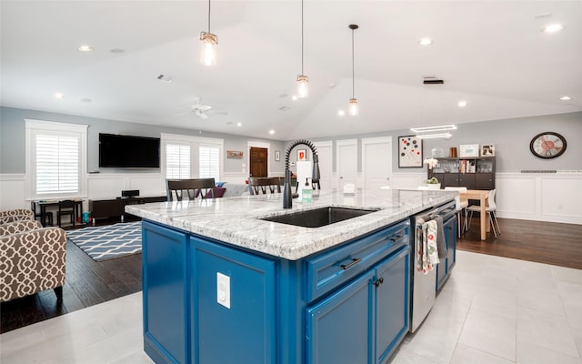 1719 Guese Rd, Houston, TX 77008 - kitchen with blue cabinets, lofted ceiling, wainscoting, dishwasher, and open floor plan