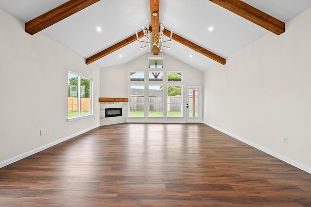 101 Callie St, Smithville, TX 78957 - unfurnished living room with beam ceiling, a stone fireplace, dark wood-style flooring, recessed lighting, and a chandelier