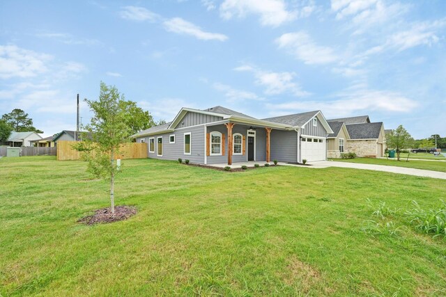 101 Callie St, Smithville, TX 78957 - ranch-style house featuring board and batten siding, an attached garage, concrete driveway, and covered porch
