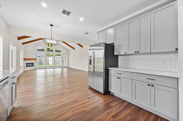 101 Callie St, Smithville, TX 78957 - kitchen with stainless steel appliances, gray cabinets, decorative backsplash, wood finished floors, and recessed lighting