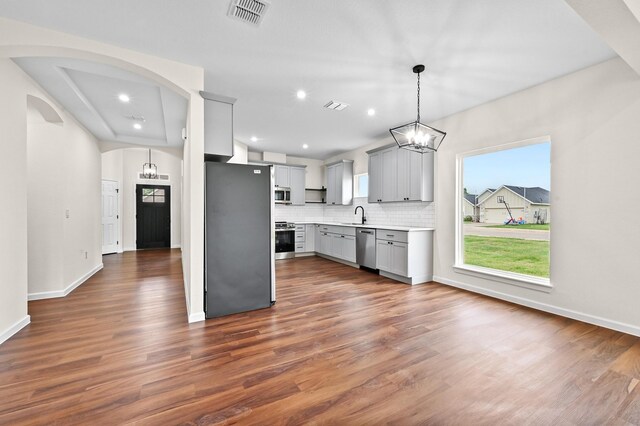 101 Callie St, Smithville, TX 78957 - kitchen featuring stainless steel appliances, gray cabinetry, dark wood finished floors, and recessed lighting