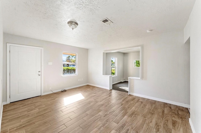 4637 Carmen St, Houston, TX 77051 - foyer featuring light wood-style flooring and a textured ceiling