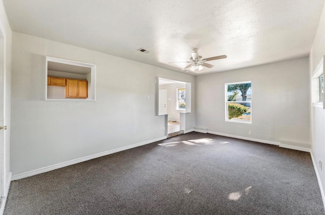 4637 Carmen St, Houston, TX 77051 - spare room featuring a ceiling fan, plenty of natural light, dark carpet, and a textured ceiling