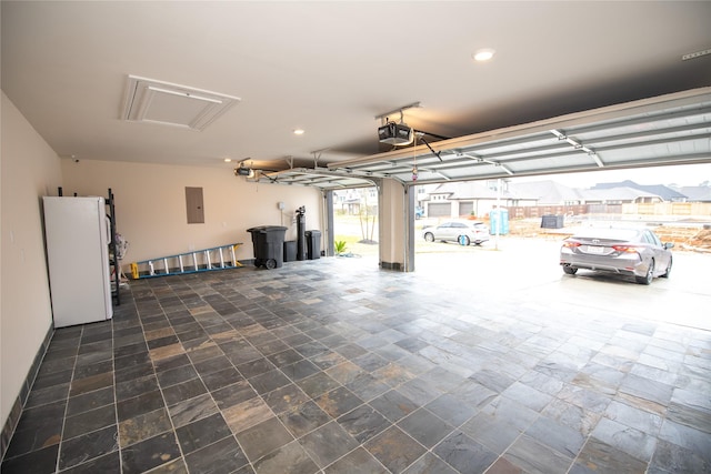 19211 Belmont Stakes Way, Tomball, TX 77377 - garage with electric panel, a garage door opener, freestanding refrigerator, and recessed lighting
