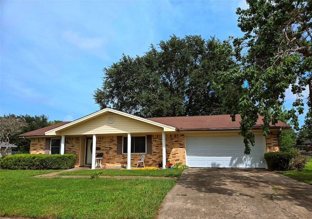 700 W 19th St, Port Arthur, TX 77640 - ranch-style house featuring a garage, driveway, a front yard, a porch, and brick siding