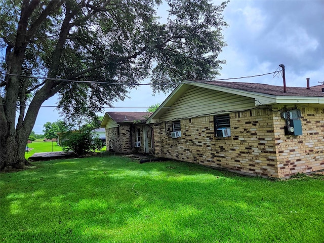 700 W 19th St, Port Arthur, TX 77640 - view of side of property featuring a yard, brick siding, and cooling unit