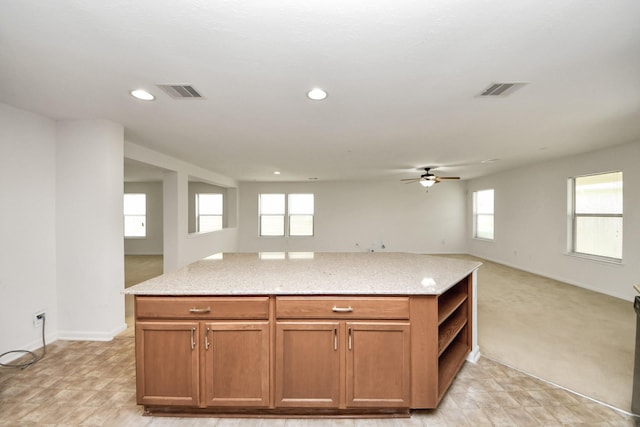 2702 Urban Glen Ct, Houston, TX 77038 - kitchen featuring open floor plan, a ceiling fan, light stone countertops, open shelves, and brown cabinets