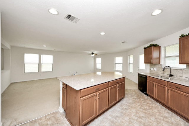 2702 Urban Glen Ct, Houston, TX 77038 - kitchen with black dishwasher, ceiling fan, open floor plan, a center island, and light stone counters