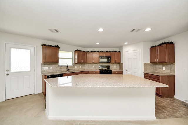 2702 Urban Glen Ct, Houston, TX 77038 - kitchen with black appliances, a center island, tasteful backsplash, light stone countertops, and recessed lighting