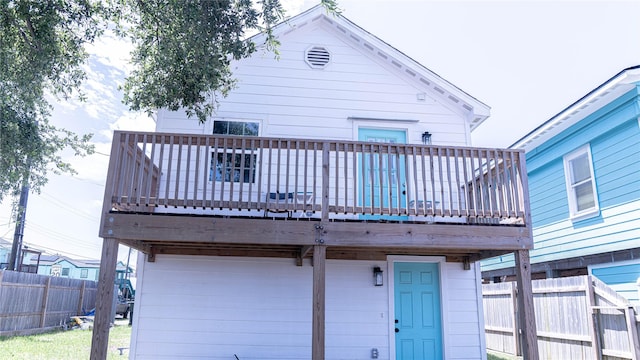 6201 Heards Ln, Galveston, TX 77551 - rear view of house with a wooden deck