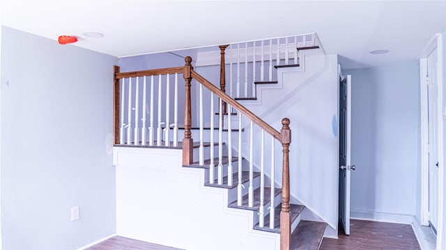 6201 Heards Ln, Galveston, TX 77551 - stairway with wood finished floors and baseboards