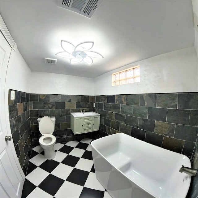 6201 Heards Ln, Galveston, TX 77551 - bathroom featuring tile walls, a freestanding tub, and vanity