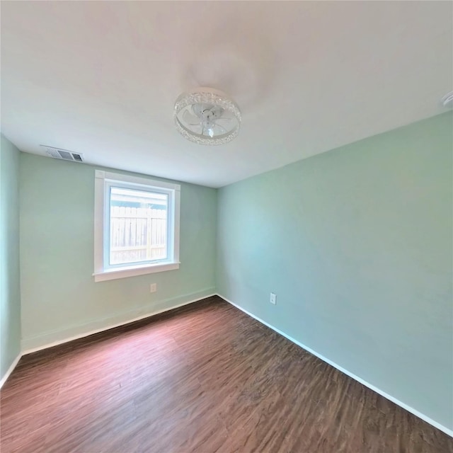 6201 Heards Ln, Galveston, TX 77551 - spare room featuring dark wood finished floors and baseboards