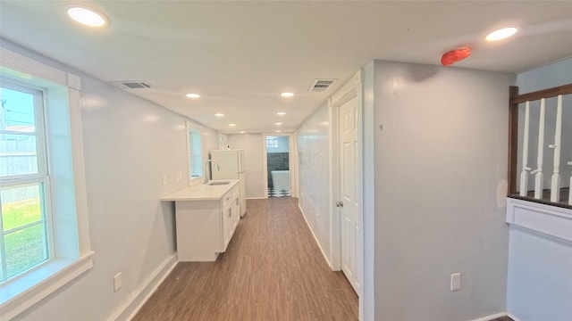 6201 Heards Ln, Galveston, TX 77551 - hall featuring wood finished floors and recessed lighting