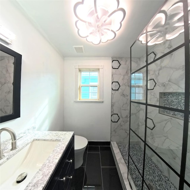 6201 Heards Ln, Galveston, TX 77551 - full bath with a chandelier, a marble finish shower, vanity, and tile patterned floors