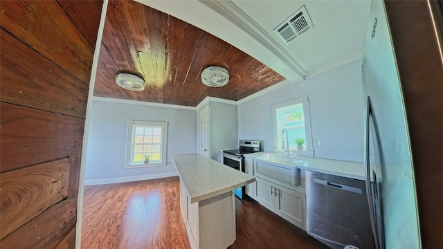 6201 Heards Ln, Galveston, TX 77551 - kitchen with stainless steel appliances, crown molding, wooden ceiling, white cabinets, and light countertops