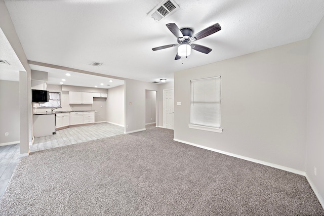 7421 Parker Rd, Houston, TX 77016 - unfurnished living room with light colored carpet, a ceiling fan, and recessed lighting
