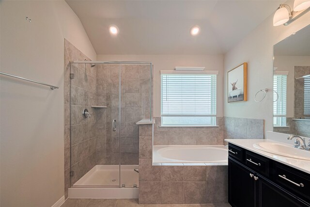 10005 Hermann Trce, Texas City, TX 77591 - bathroom with healthy amount of natural light, a bath, vanity, a shower stall, and vaulted ceiling